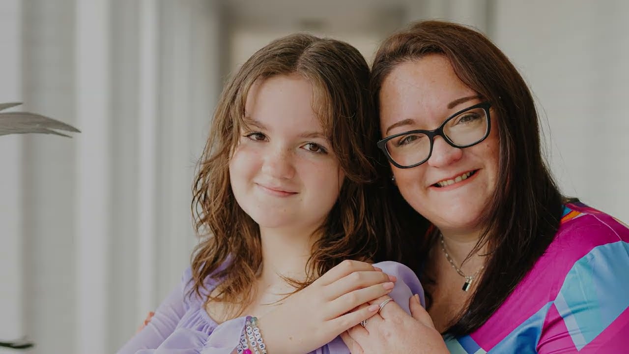 Mother and Daughter together smiling at camera